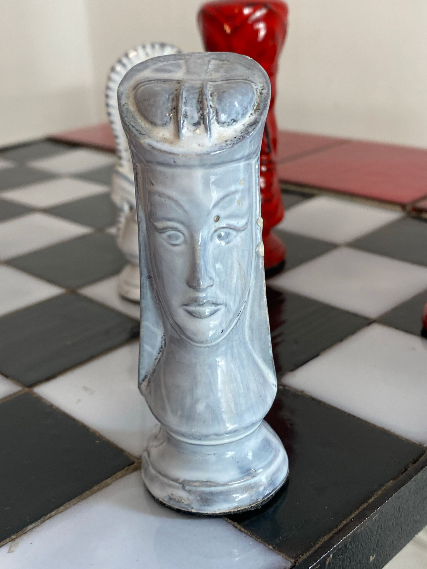 Chess set with ceramic board and pieces.