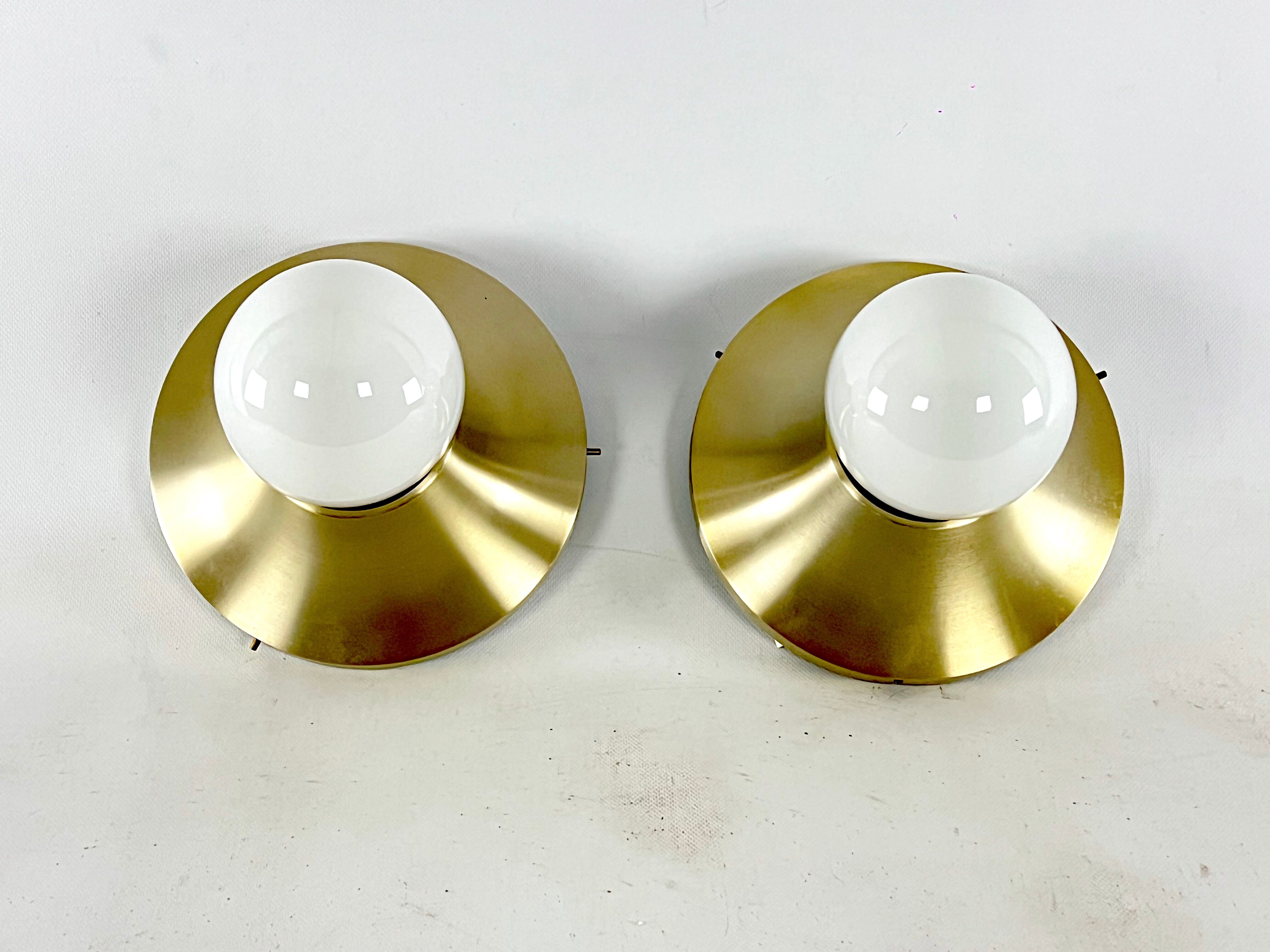 Stilux Milano, vintage round gilded aluminum wall lamps from 60s. Set of two