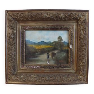 Painting on old panel framed and signed, cow and farmer