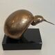Bronze sculpture representing a stylised bird on a black marble base, signed and numbered.