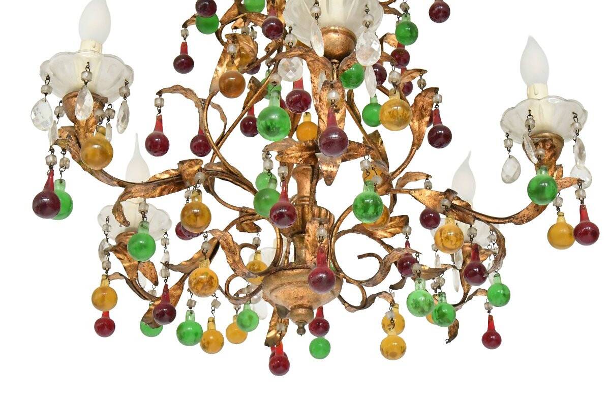 Lustrous chandelier with two wall lights decorated with foliage and pendants.