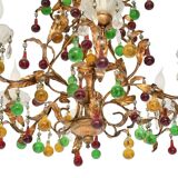 Lustrous chandelier with two wall lights decorated with foliage and pendants.