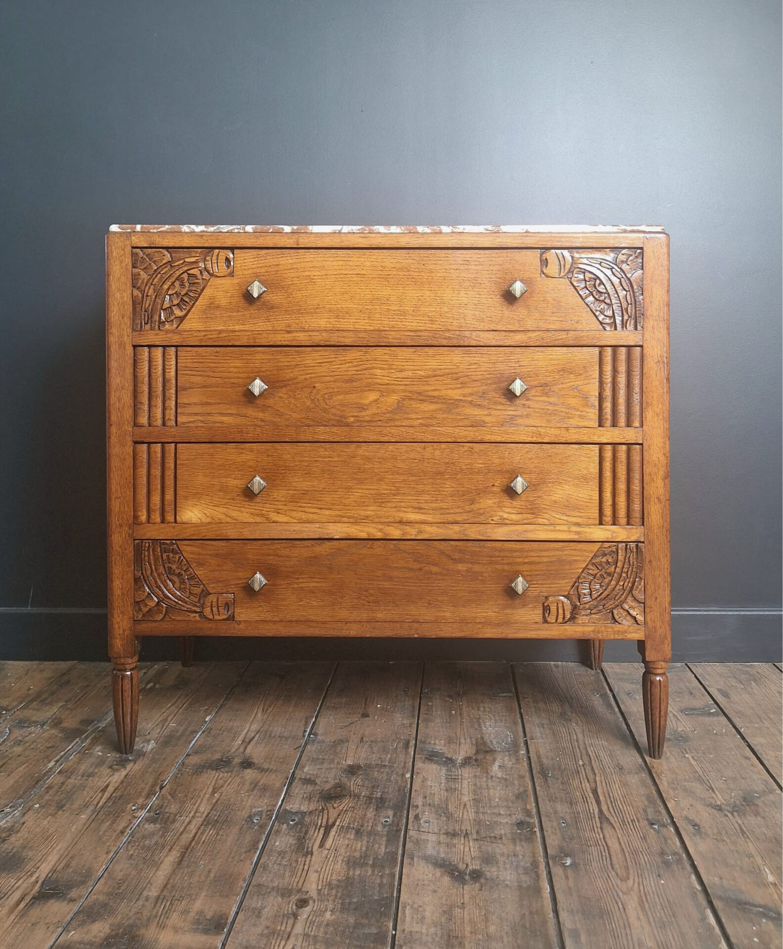 Art Deco commode with marble top, vintage antique furniture.