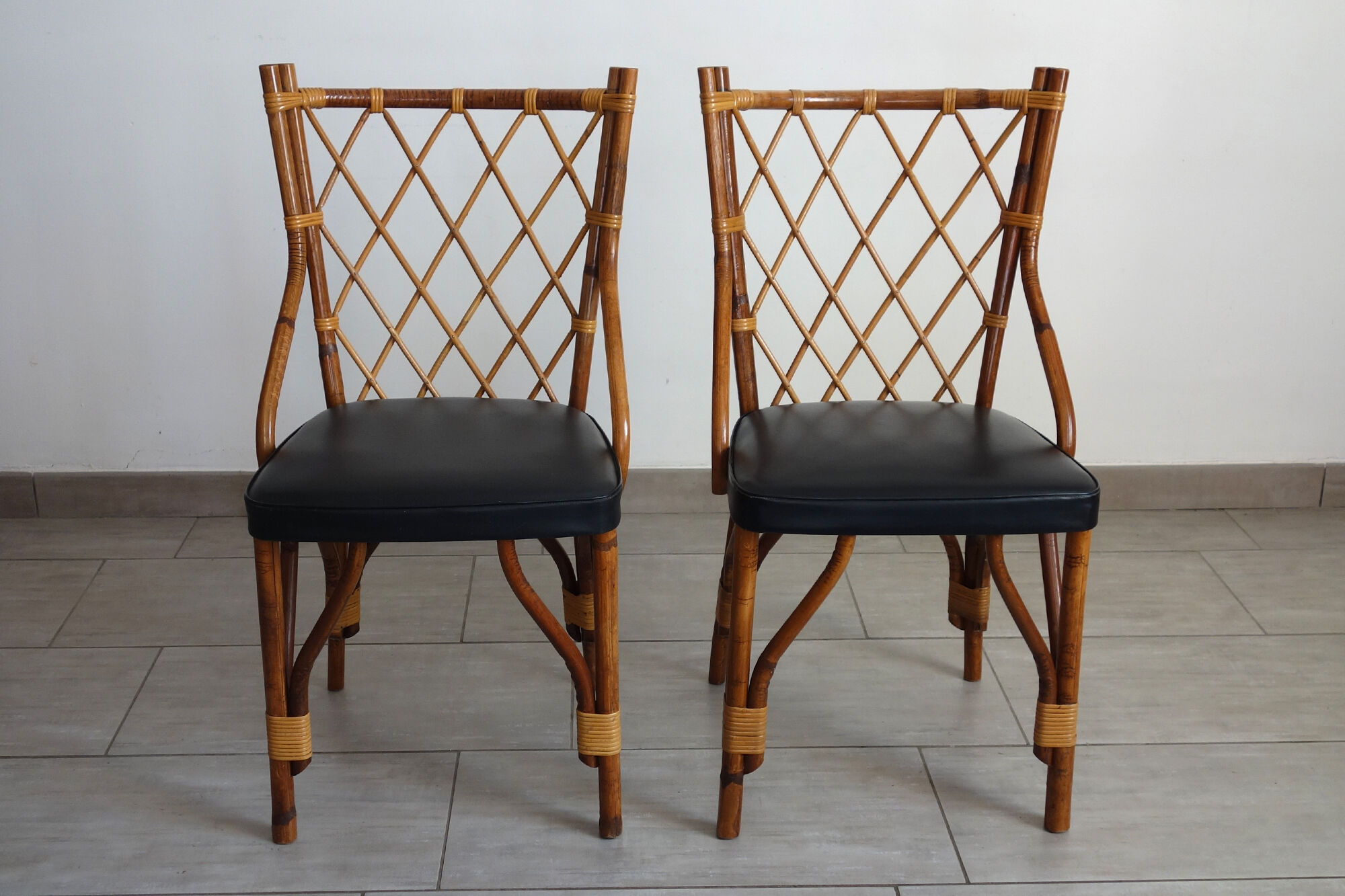 Pair of rattan and black skai bamboo chairs, 60s