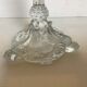 Thick moulded glass candlestick with fish and flowers.
