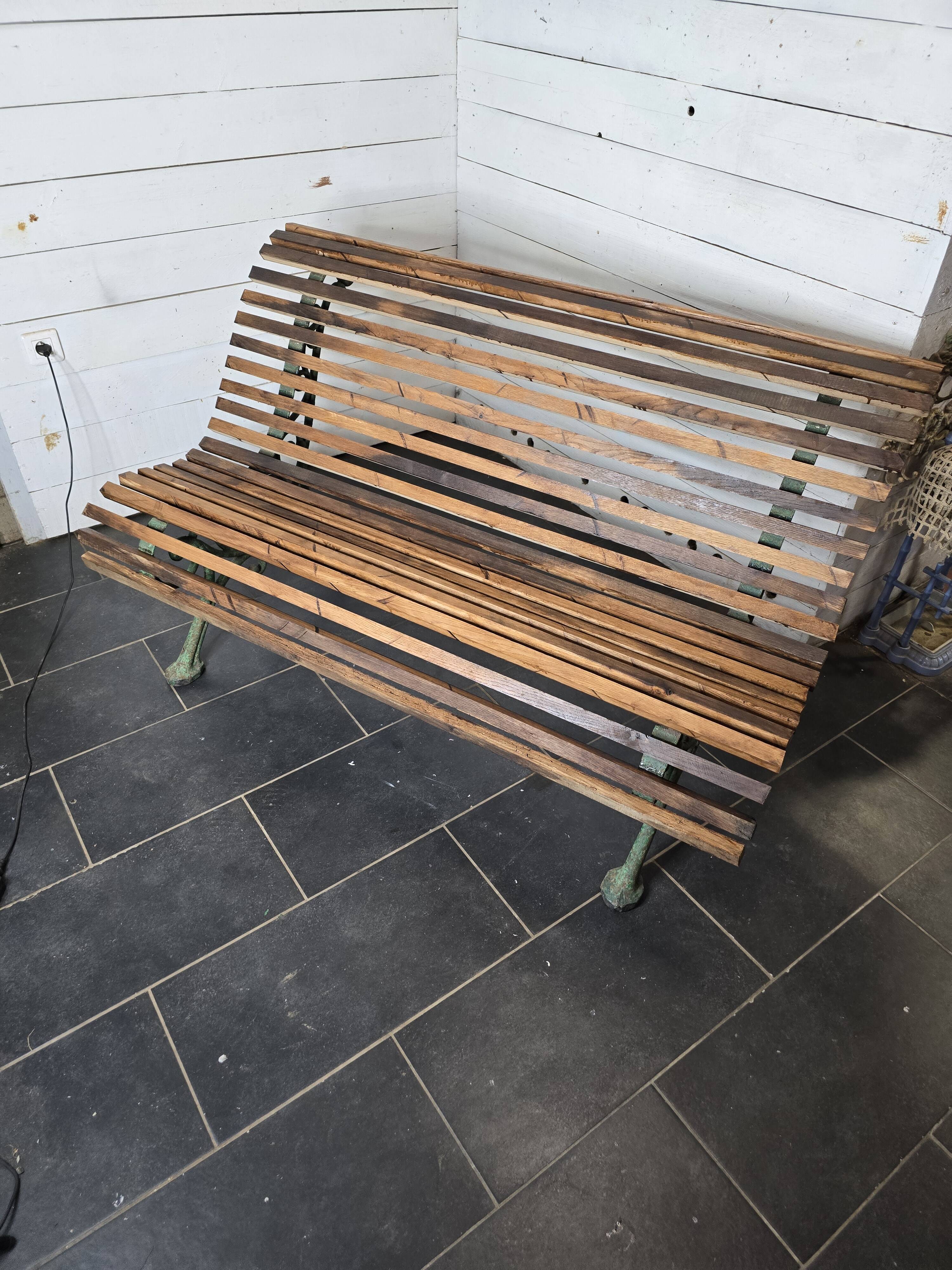 Old cast iron garden bench with oak slats