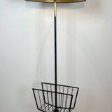 Designer floor lamp in black lacquered metal and brass, incorporating a magazine rack