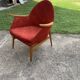Red fabric armchair in Mid-Century Scandinavian style, high back and light wood legs (1960s)