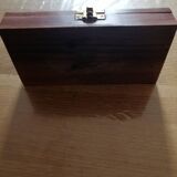 Magnifying glass and paper cutter in a vintage wooden box