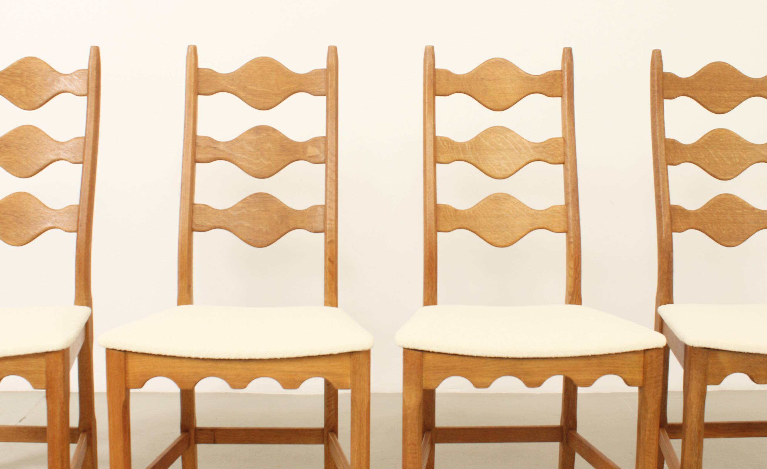 Four oak dining chairs by Henning Kjaernulf.