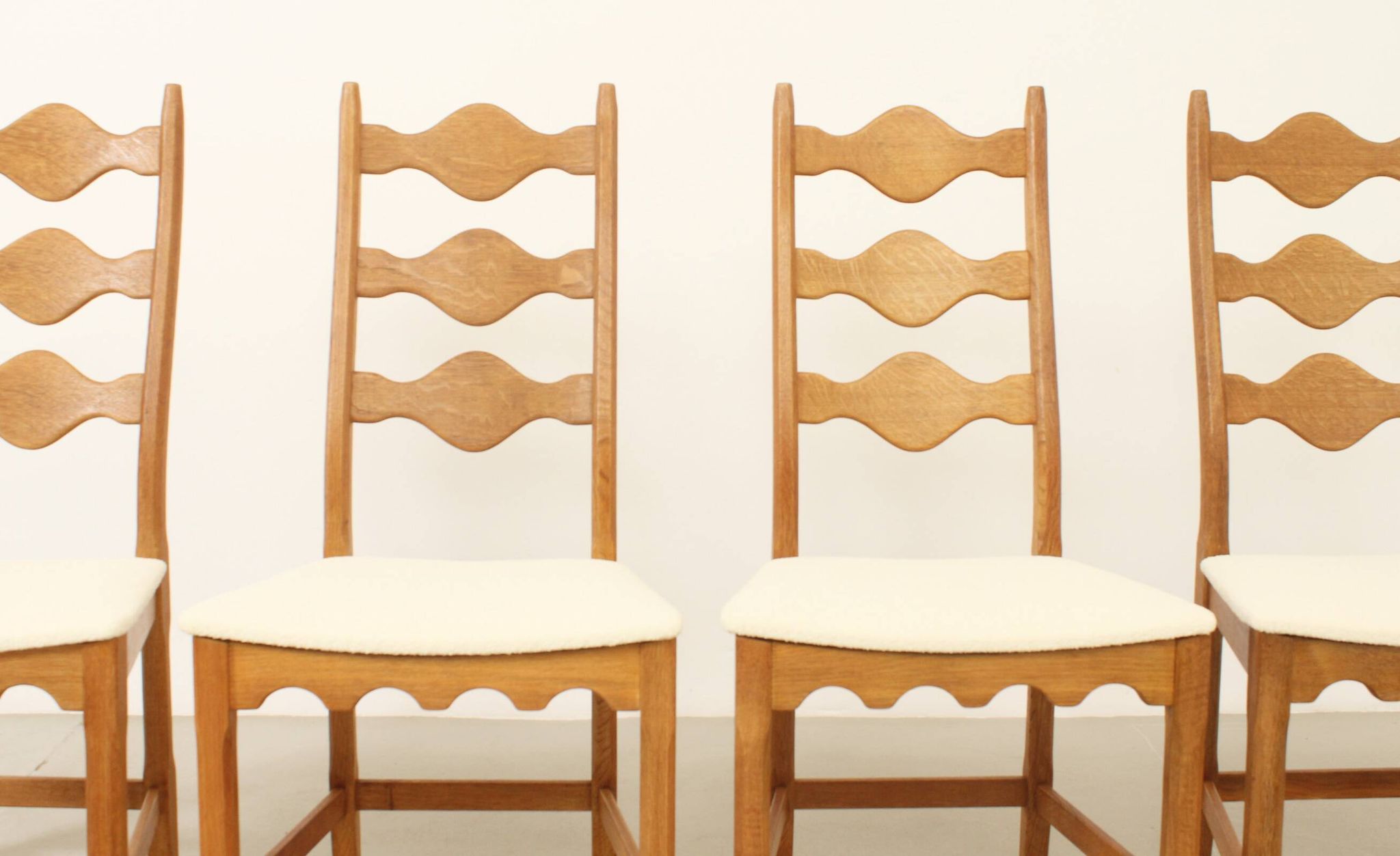 Four oak dining chairs by Henning Kjaernulf.