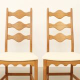 Four oak dining chairs by Henning Kjaernulf.