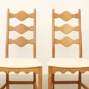 Four oak dining chairs by Henning Kjaernulf.
