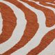 Vintage orange and white zebra rug in ethnic style.