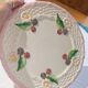 Footed dessert plate in barbotine porcelain, marked FG.