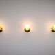 Set of three brass sconces with decorated yellow glass shades