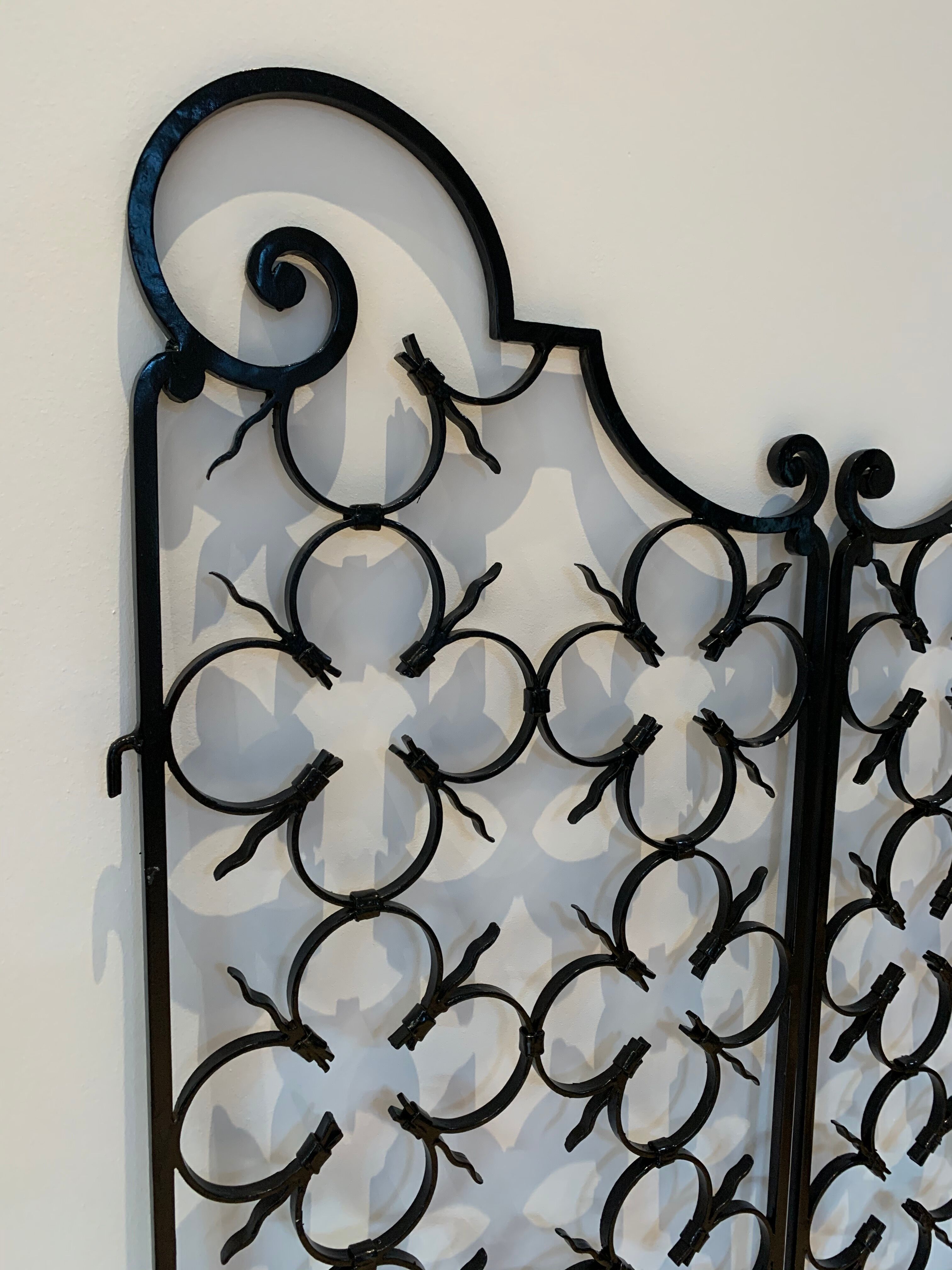 Ancient pair of door opening gates has hell volutes forged craftsmanship
