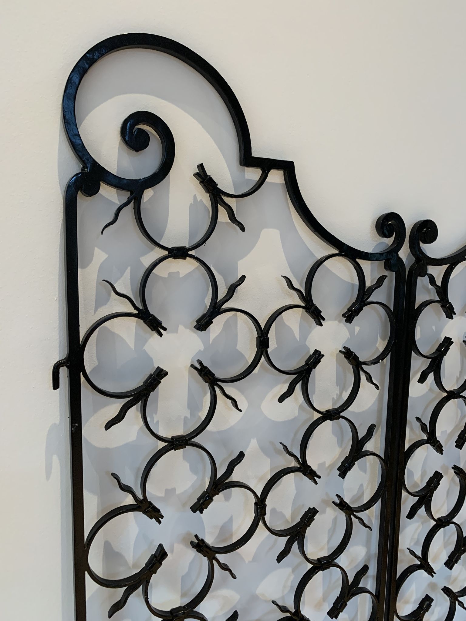 Ancient pair of door opening gates has hell volutes forged craftsmanship