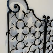 Ancient pair of door opening gates has hell volutes forged craftsmanship