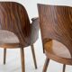 Pair of curved wooden shell armchairs in the style of Oswald Haerdtl.