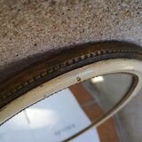 Old oval guilloche mirror, gilded and painted