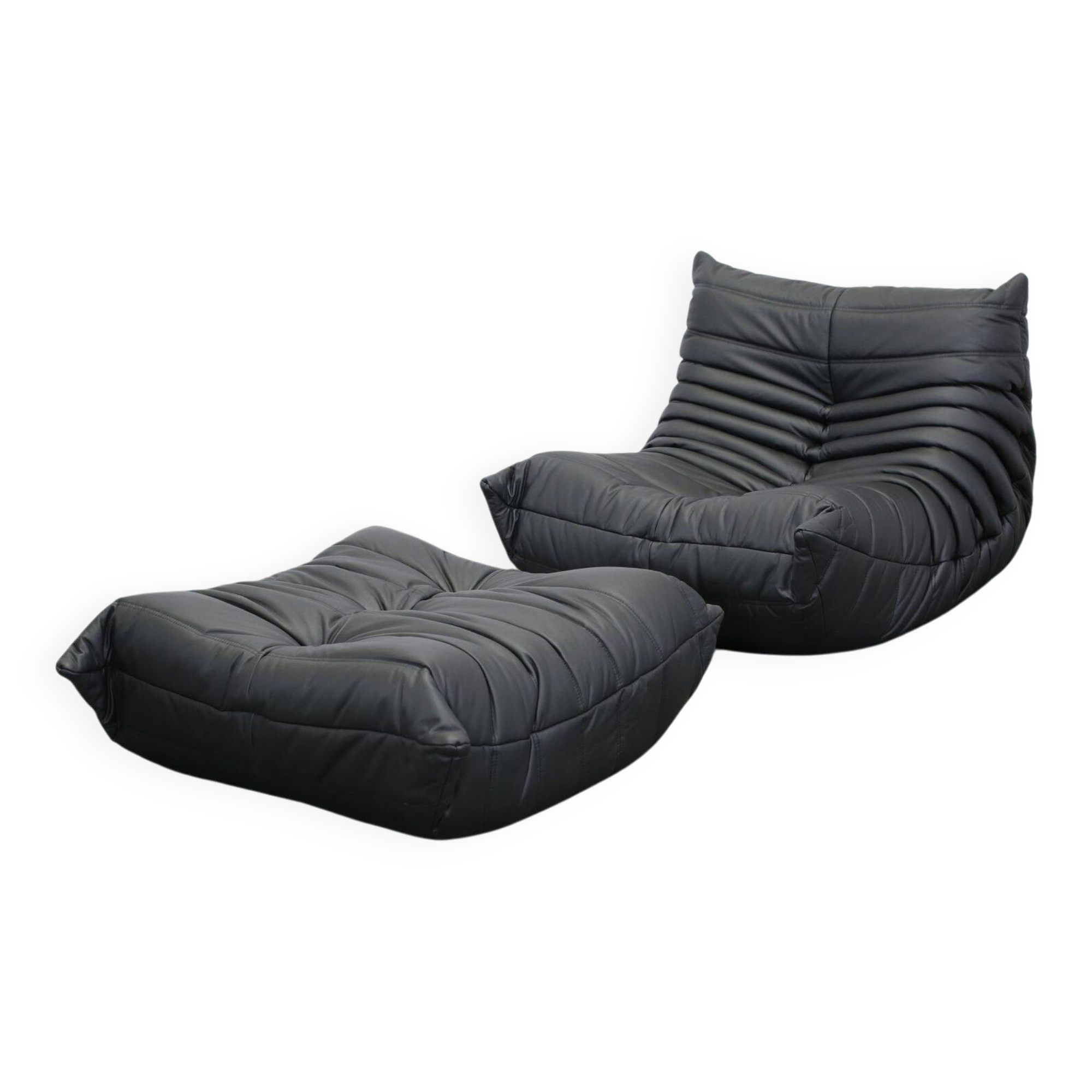 Togo armchair and footrest in black leather by Ligne Roset, designed by Michel Ducaroy.