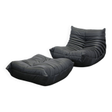 Togo armchair and footrest in black leather by Ligne Roset, designed by Michel Ducaroy.