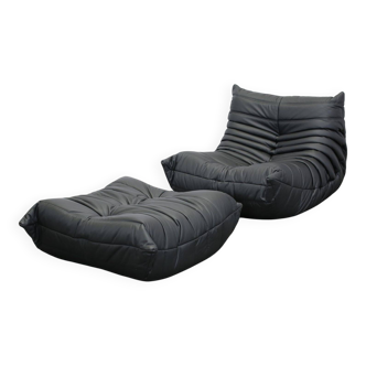Togo armchair and footrest in black leather by Ligne Roset, designed by Michel Ducaroy.