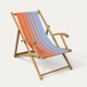 Vintage deck chair with orange and blue striped fabric, original patina.