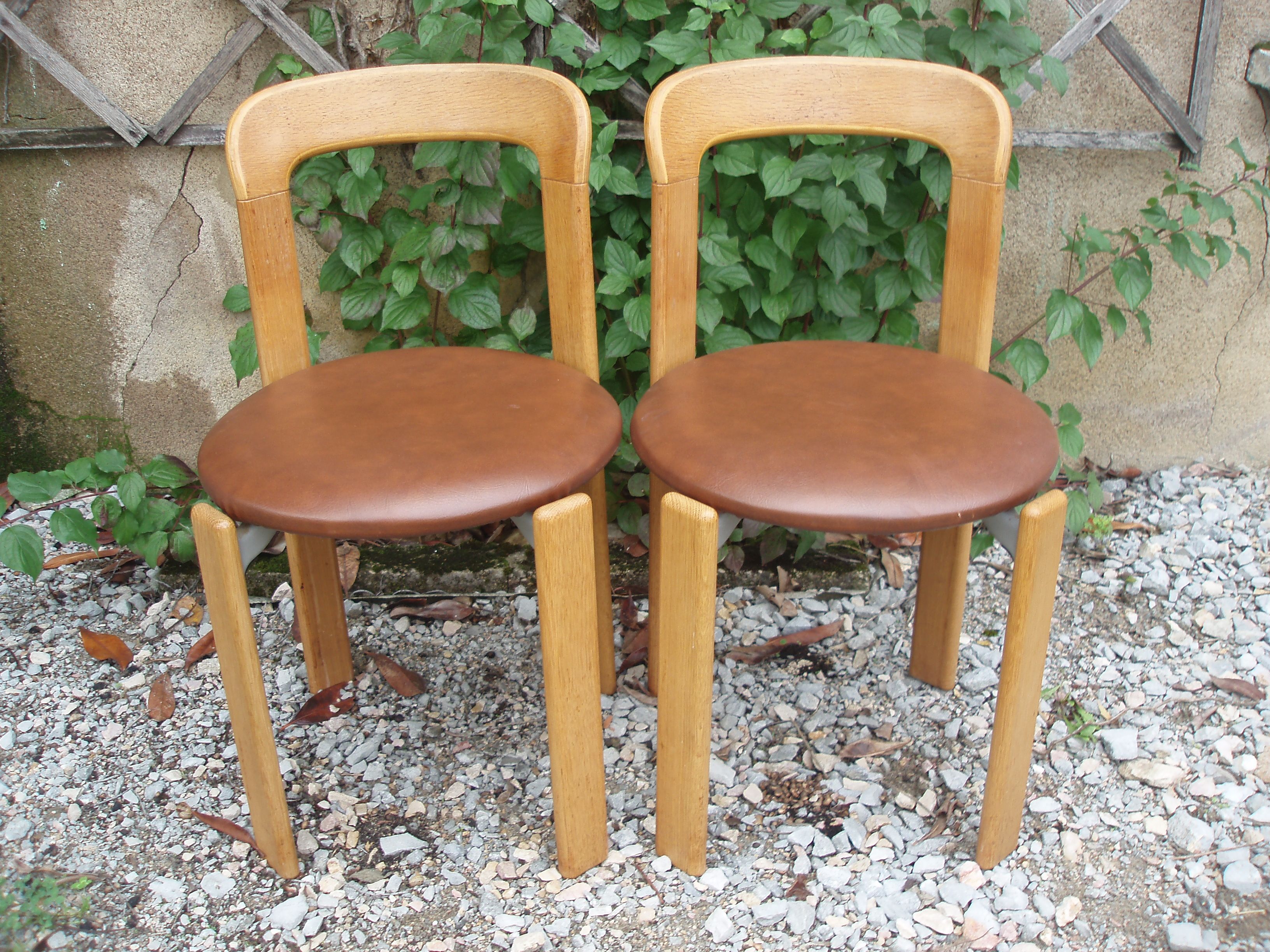 Pair of chairs by Swiss designer Bruno Rey in wood and brown skai