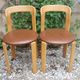 Pair of chairs by Swiss designer Bruno Rey in wood and brown skai