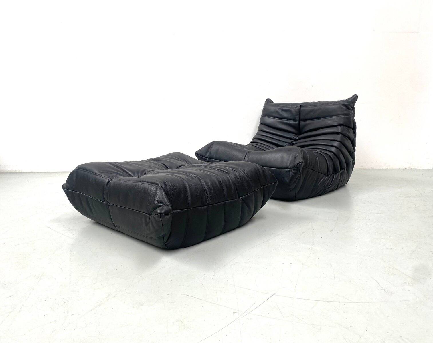 Set of French Togo lounge chair and ottoman in black leather attributed to Michel Ducaroy for Ligne Roset, 1970s