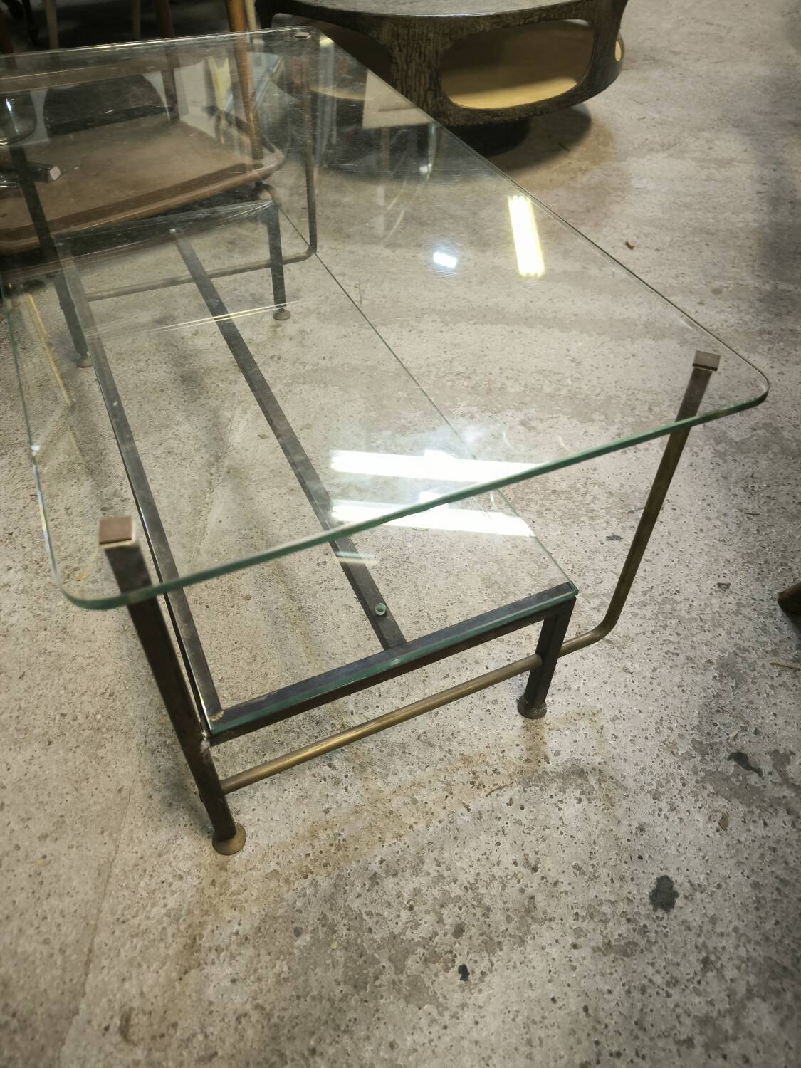 Double-tier coffee table in steel and bronze as well as glass
