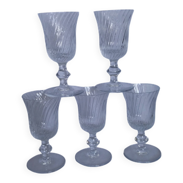 Ancient footed crystal glasses with relief twisted fluted goblets.