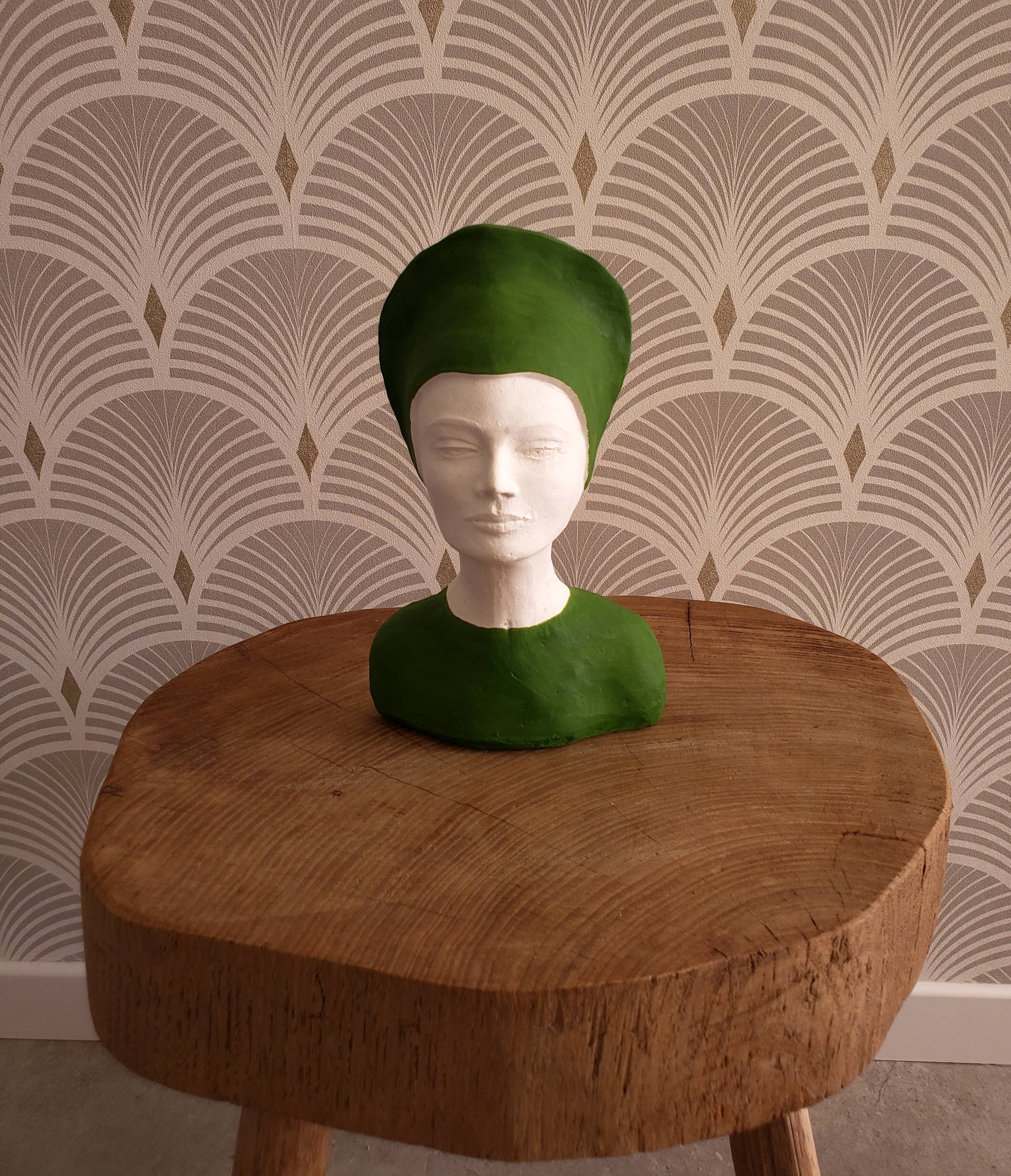 Bust of a woman in green and white plaster