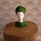 Bust of a woman in green and white plaster