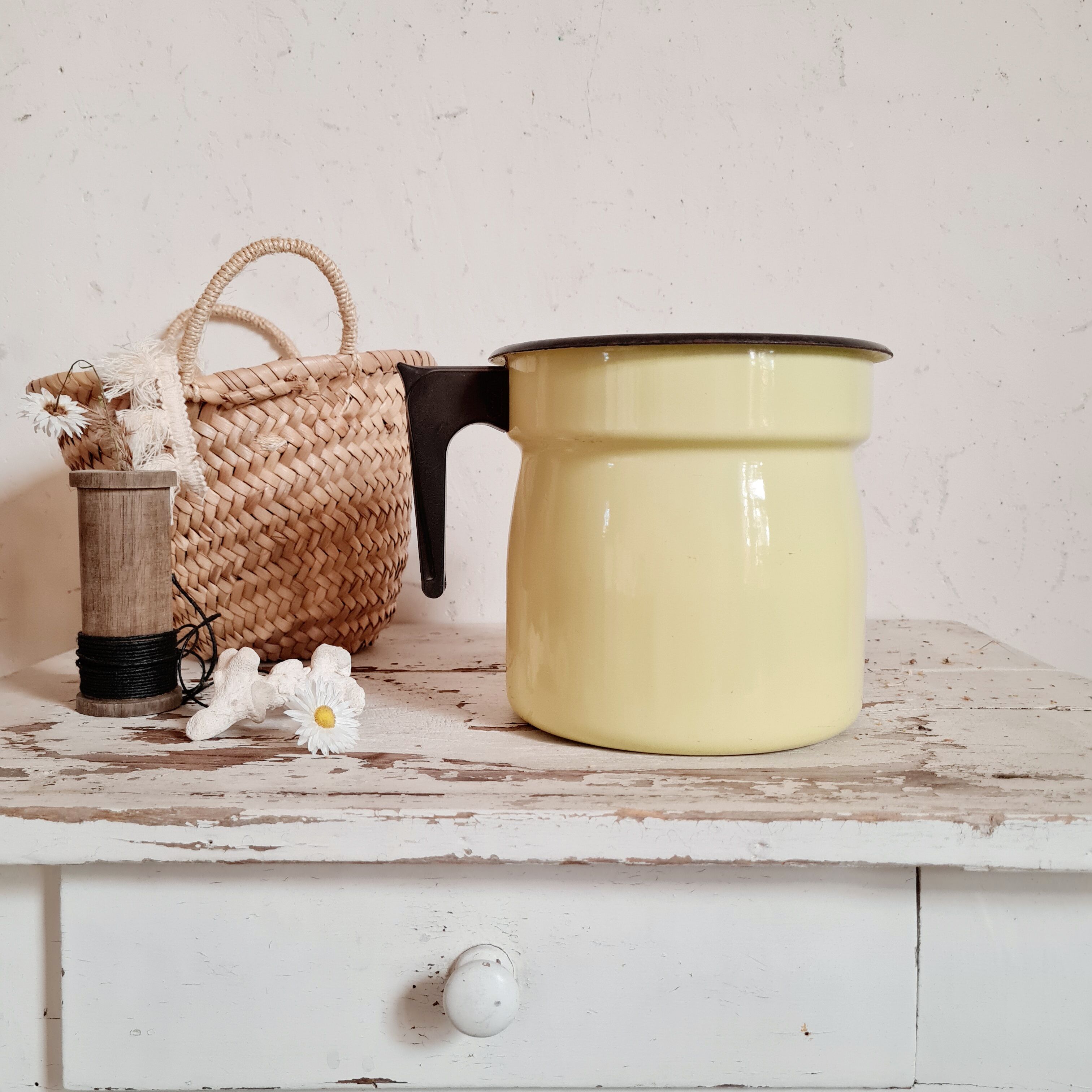 Old pitcher in yellow enamelled sheet metal