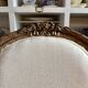 Medallion back chair in moulded wood and beige fabric.