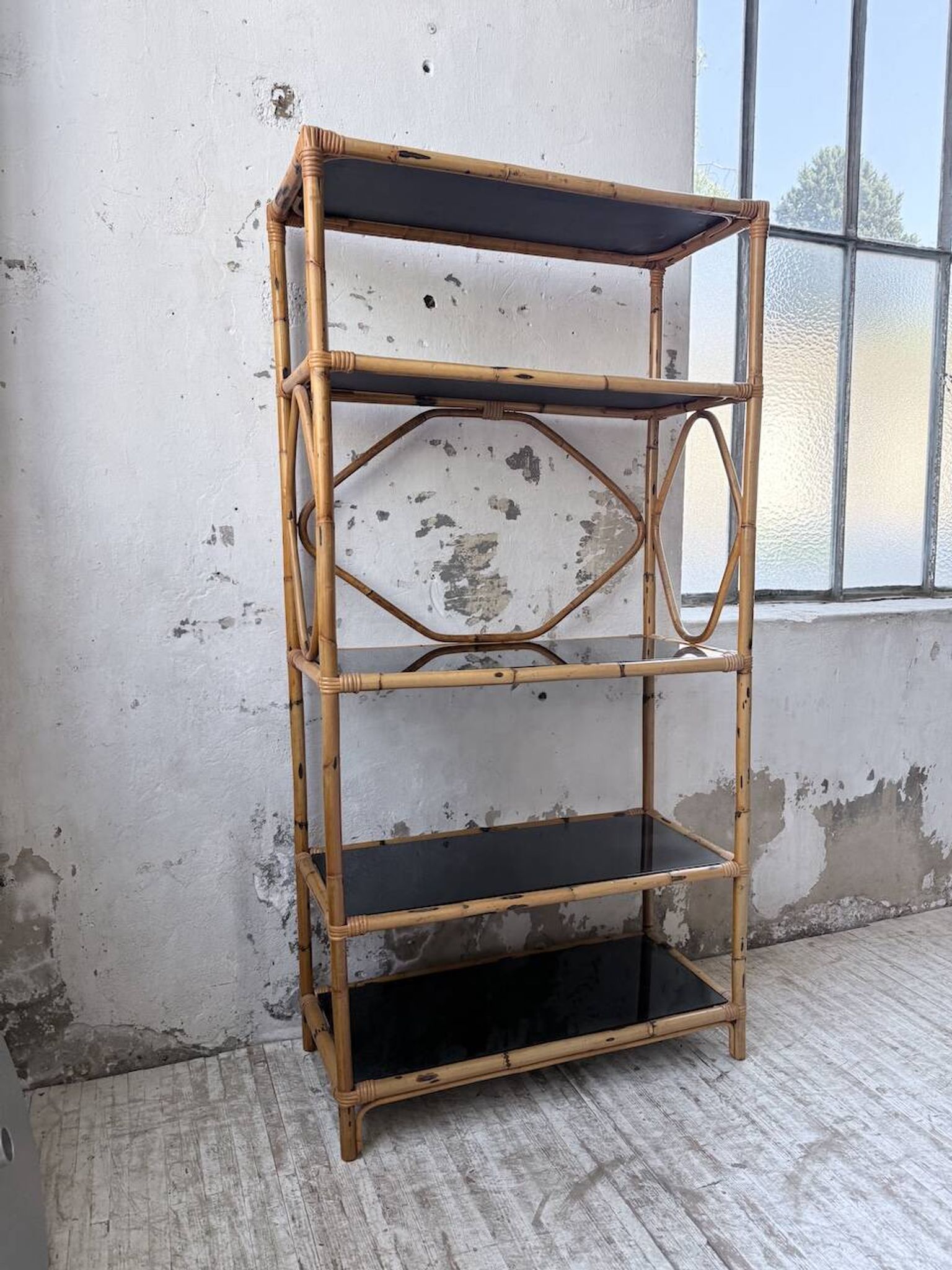 Rattan bookshelf and black glasses