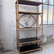Rattan bookshelf and black glasses