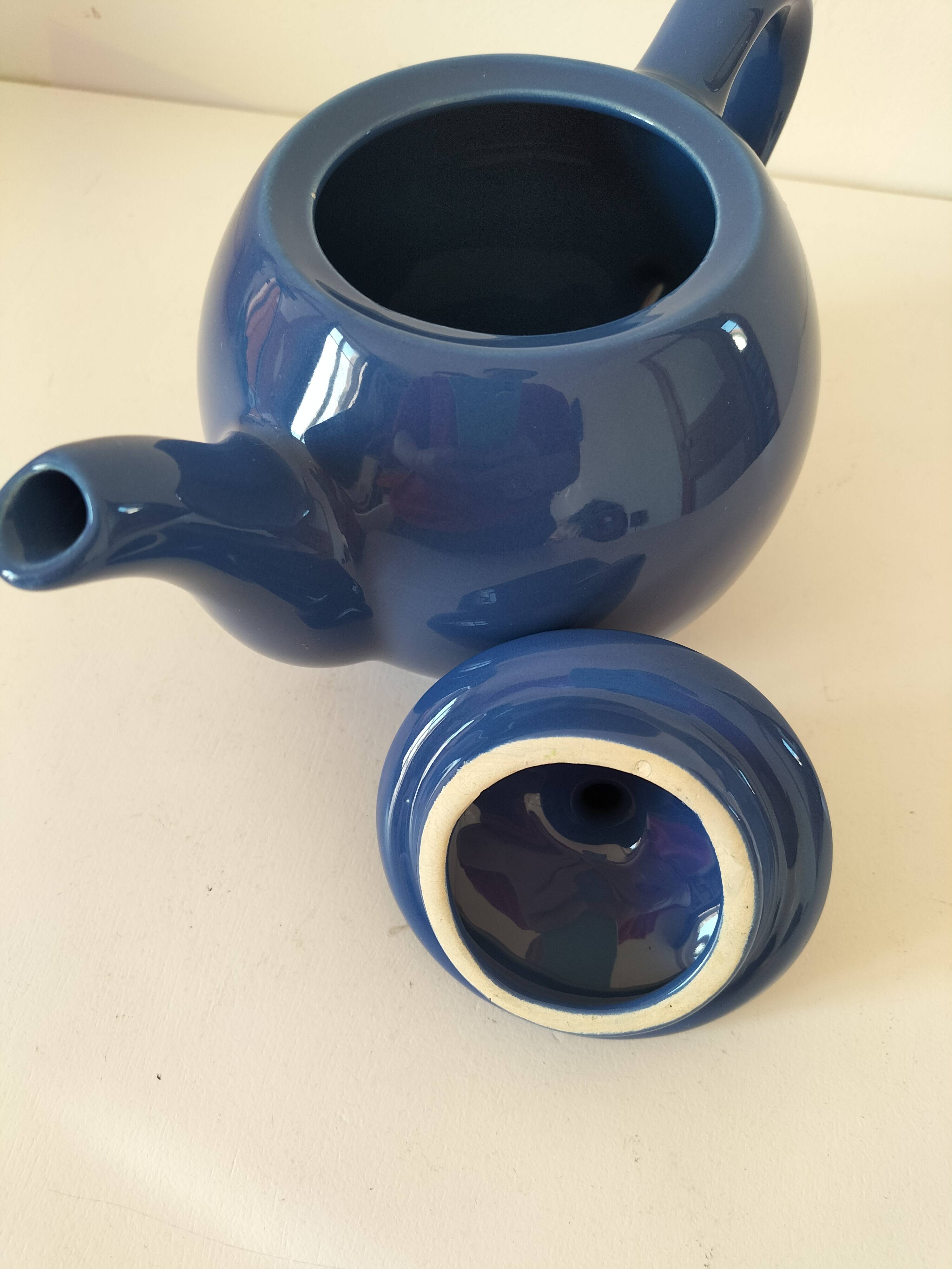 Vintage deep blue teapot, minimalist round shape.