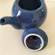 Vintage deep blue teapot, minimalist round shape.