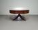 Mahogany Victorian "Heldense" coffee table / drum table with leather top on brass wheels. 1980s