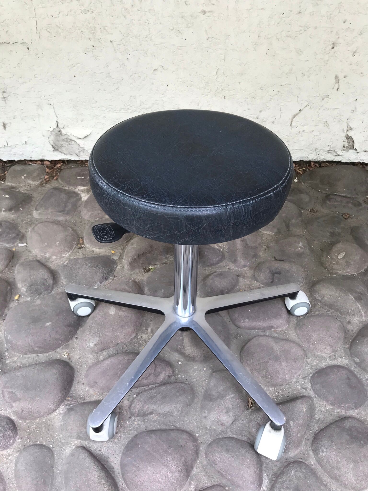 Stool on metal stand in star on wheels sitting round padded skaï bluish