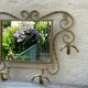 Wall-mounted gilded wrought iron coat rack with mirror