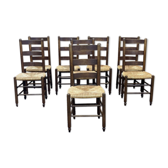 Suite de 8 chaises en chêne et assises paille - travail des années 1950