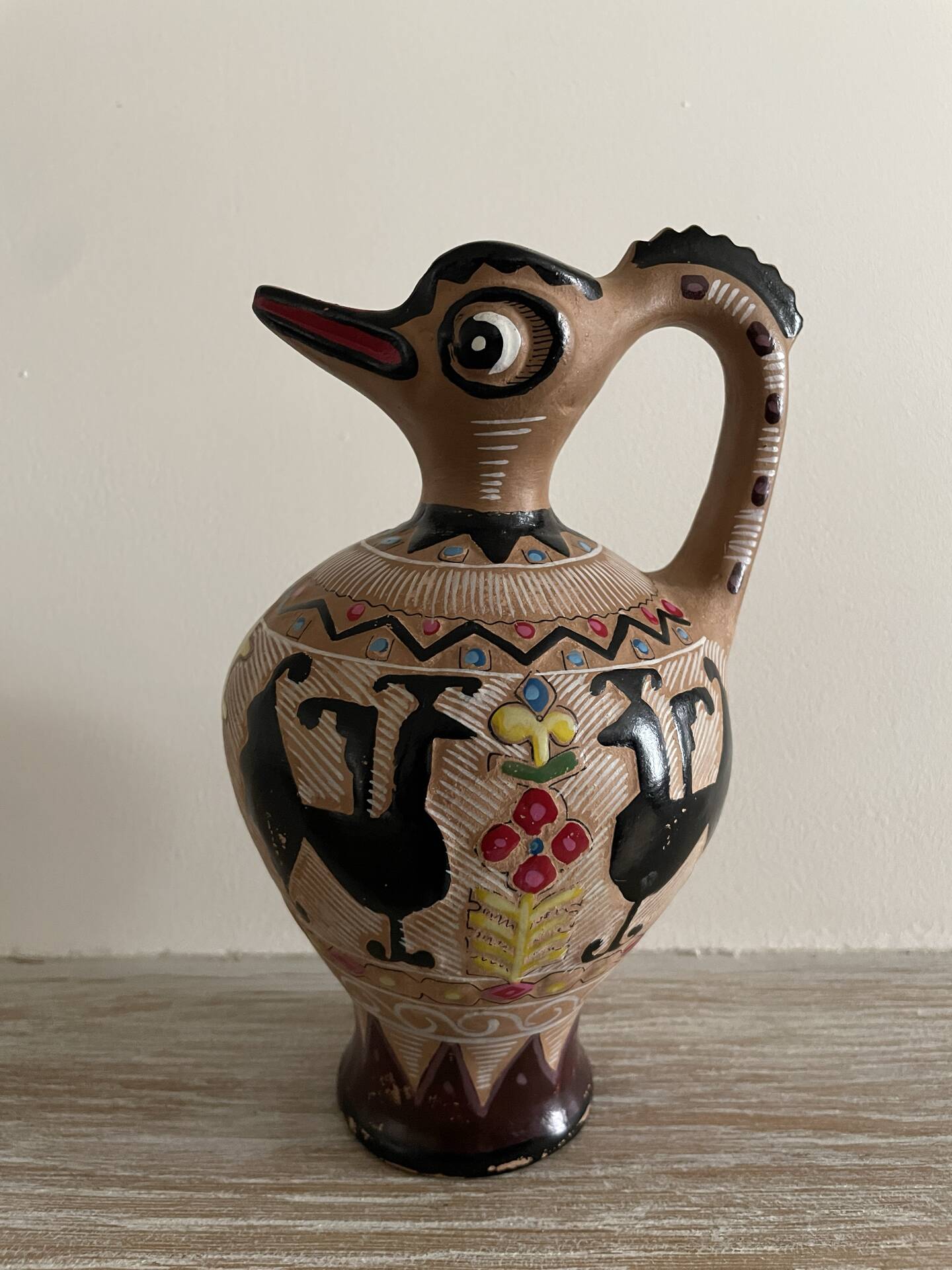 Clay pitcher with a bird head