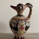 Clay pitcher with a bird head