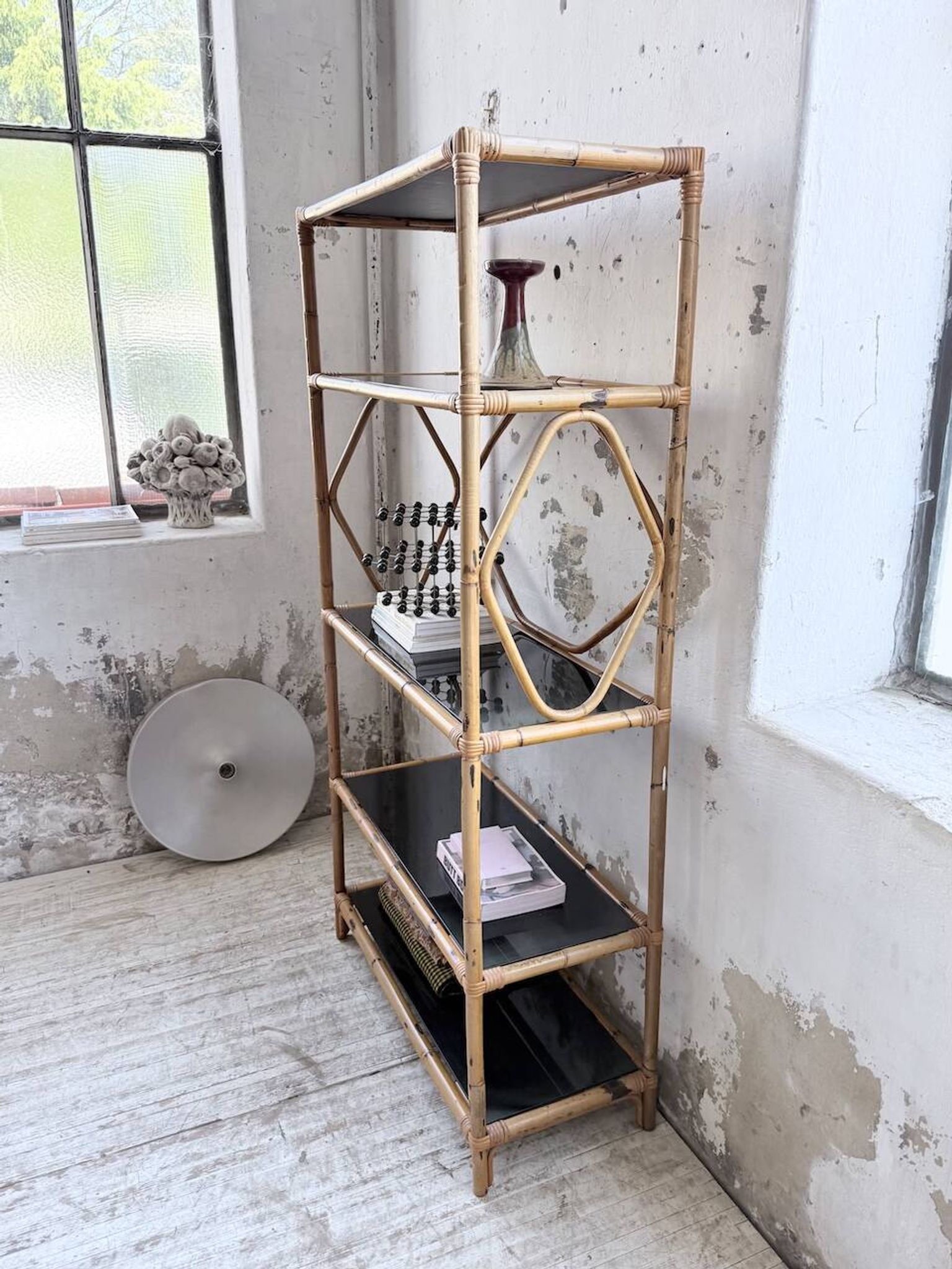 Rattan bookshelf and black glasses