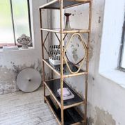 Rattan bookshelf and black glasses